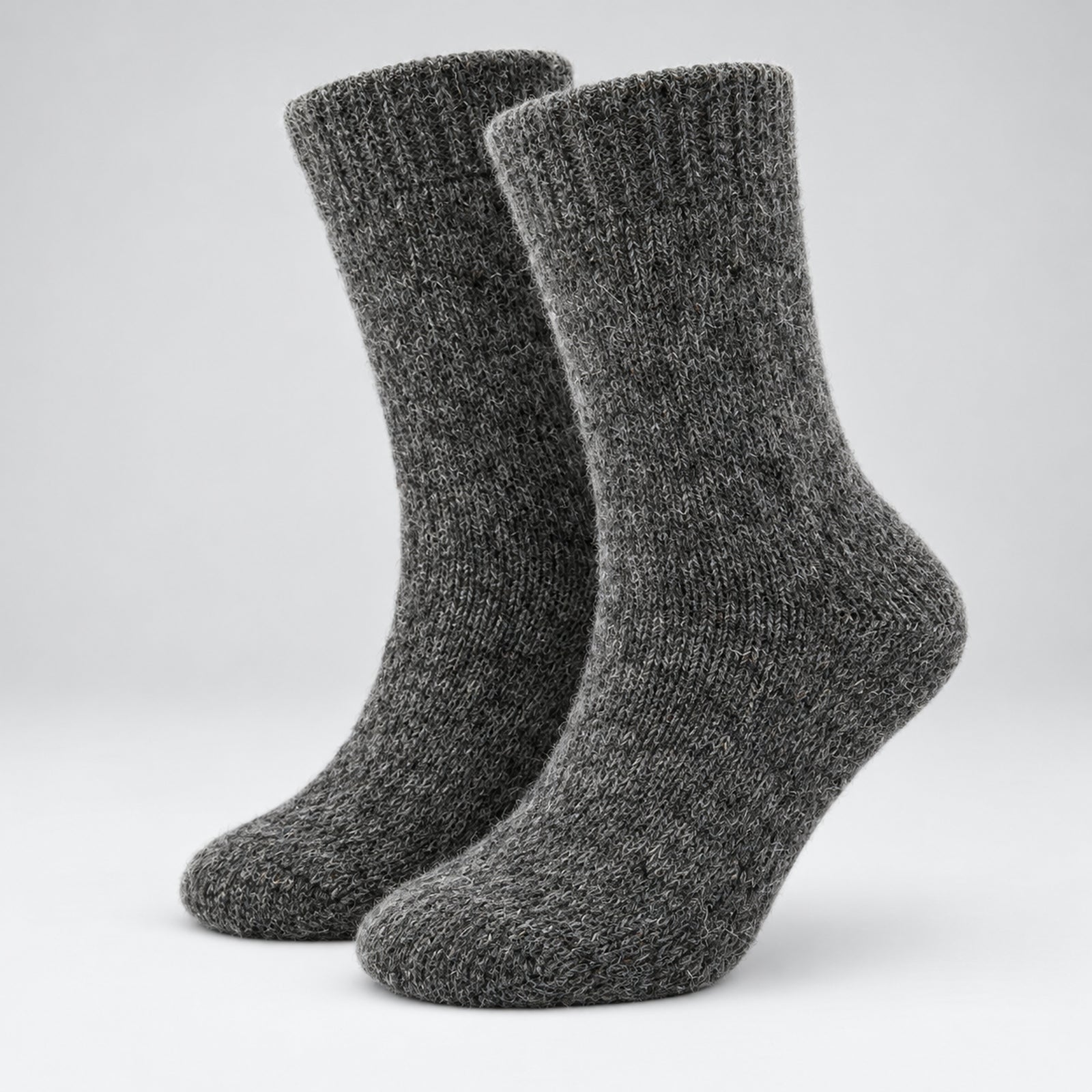 A pair of dark gray heathered ribbed knit crew socks shown on a light gray gradient studio background.