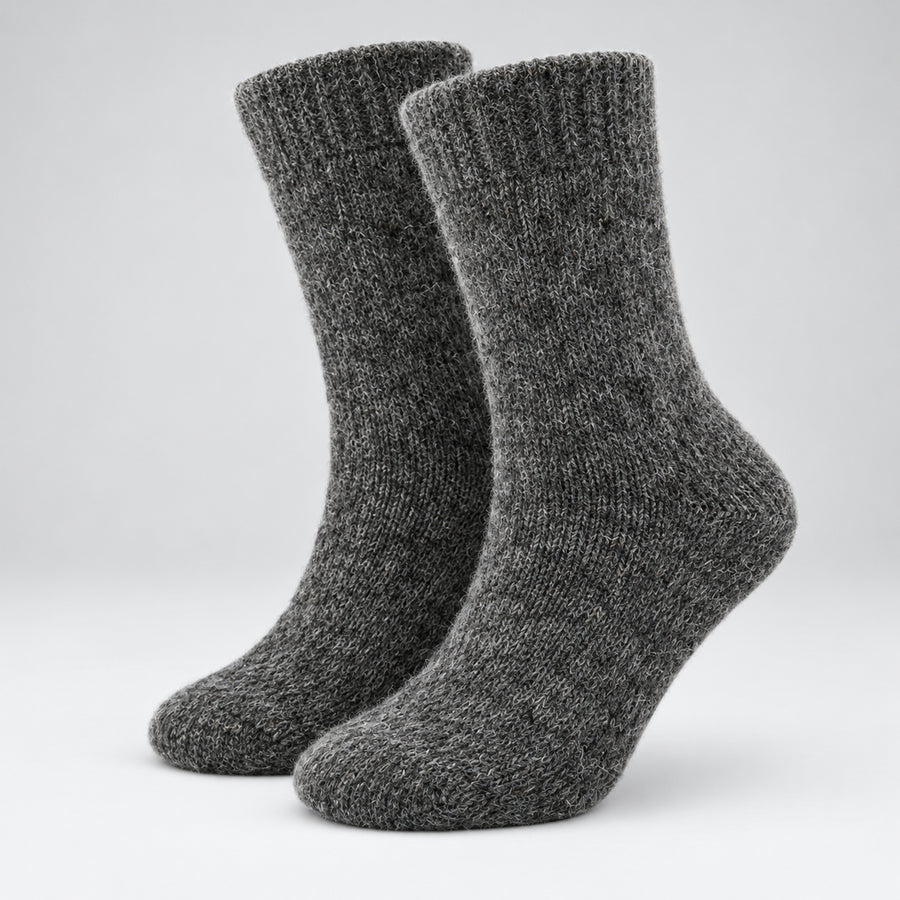 A pair of dark gray heathered ribbed knit crew socks shown on a light gray gradient studio background.