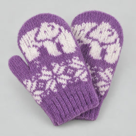 A pair of purple knit mittens with white fair isle patterns of polar bears and snowflakes, displayed on a neutral gray background.