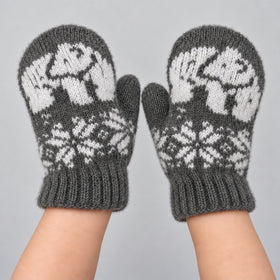 A pair of knit mittens in heather gray and white, featuring a polar bear pattern on the back of the hands and a snowflake design on the palms, displayed on a neutral gray background.
