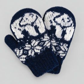 A pair of navy blue and white knit mittens with a traditional Nordic snowflake and animal pattern, displayed on a neutral gray background.