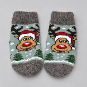 A pair of gray knit baby socks featuring a festive Christmas design with a reindeer wearing a Santa hat, green trees, and white snowflakes on a light gray background.
