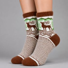 A pair of crew socks worn on feet, featuring a brown and cream knit pattern with a green and brown deer design on the upper section, set against a solid gray background.