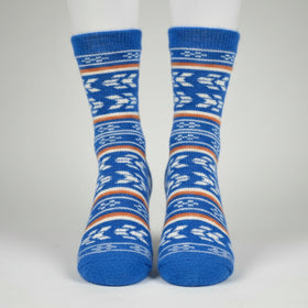Blue patterned socks on a white mannequin against a gray background