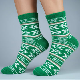 Green patterned socks worn by a person on a gray background