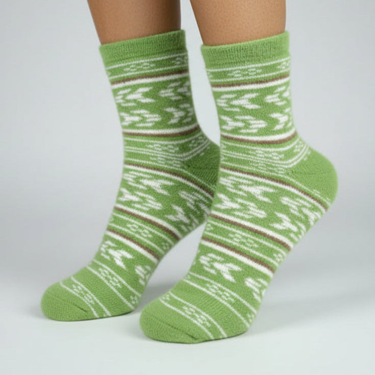 Green patterned socks worn with white tights on a gray background