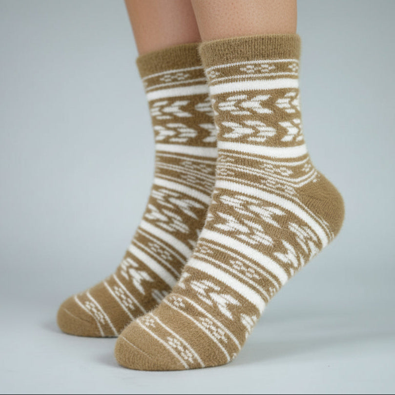 Pair of brown and white patterned socks on a plain background