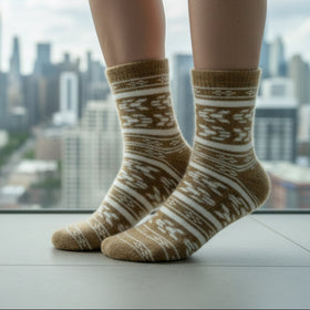 Person wearing patterned socks with a cityscape view in the background