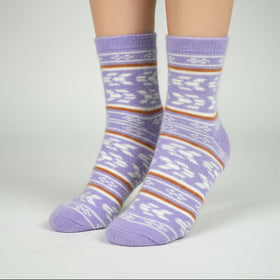 Purple striped socks worn by a person on a gray background