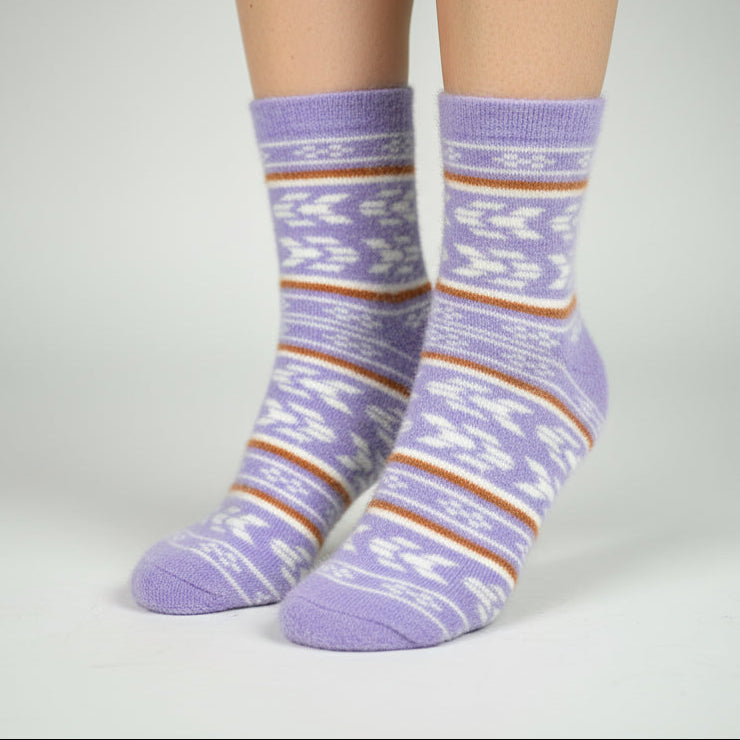 Purple striped socks worn by a person on a gray background