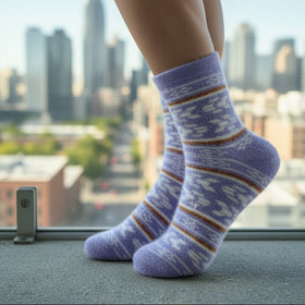 Person wearing striped socks with a cityscape in the background