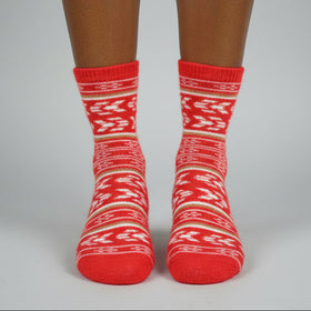 Red and white patterned socks on a neutral background