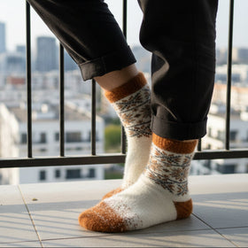 Person wearing patterned socks with a cityscape in the background