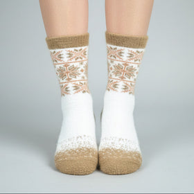 White socks with brown patterns worn by a person on a gray background