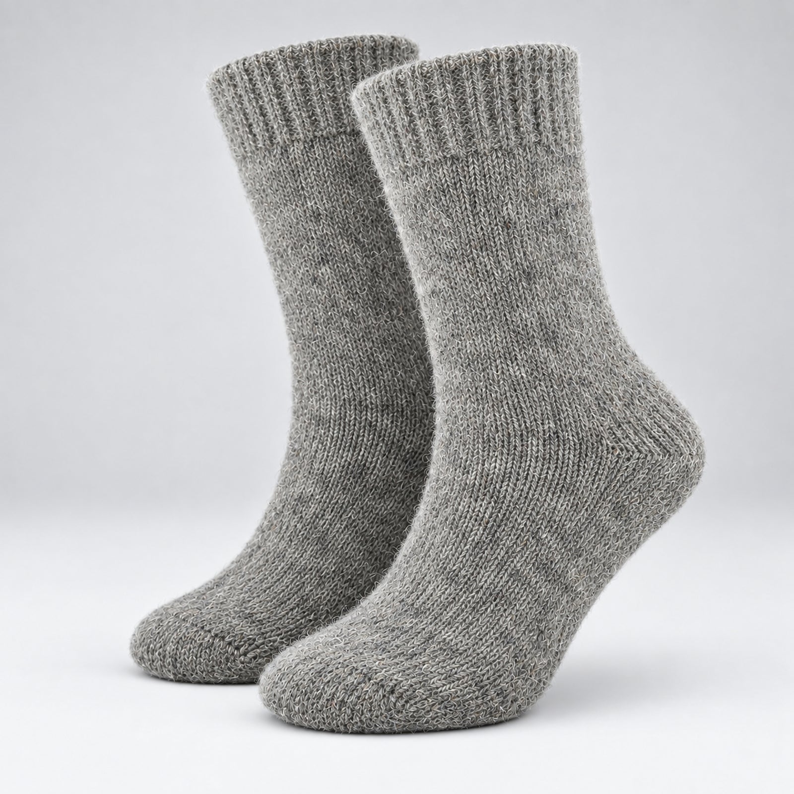 A pair of heather gray knit crew socks shown on invisible forms against a light gray studio background.