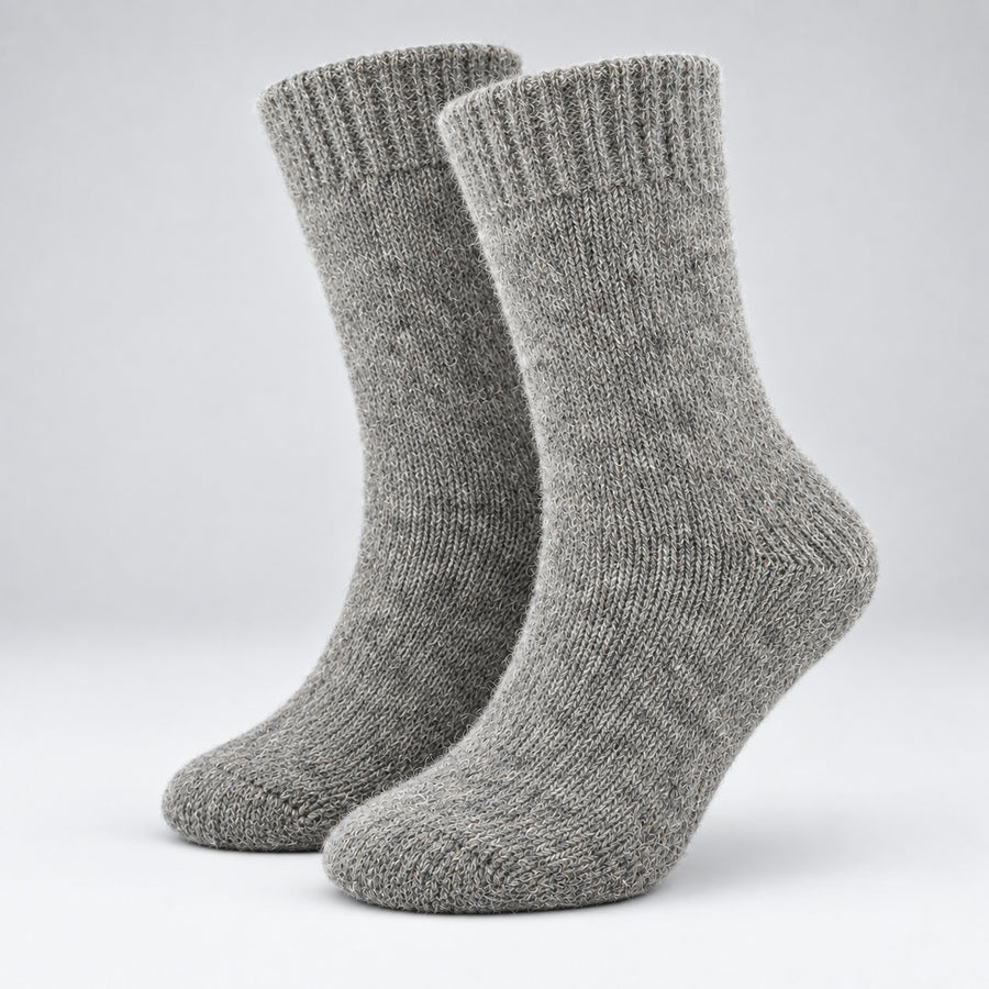 A pair of heather gray knit crew socks shown on invisible forms against a light gray studio background.