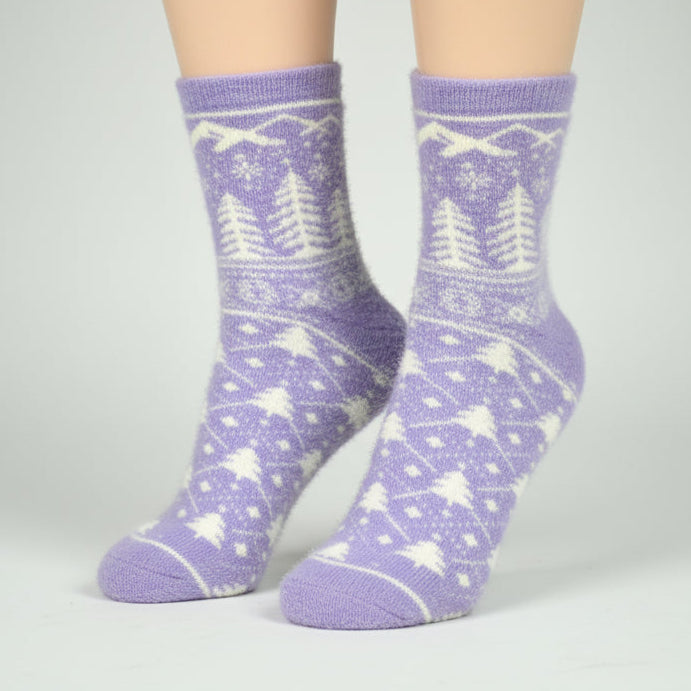 Purple patterned socks worn by a person on a gray background