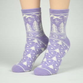 Purple patterned socks worn by a person on a gray background