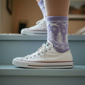 White sneakers with purple patterned socks on a step