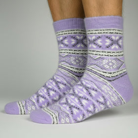 Purple patterned socks worn by a person on a gray background