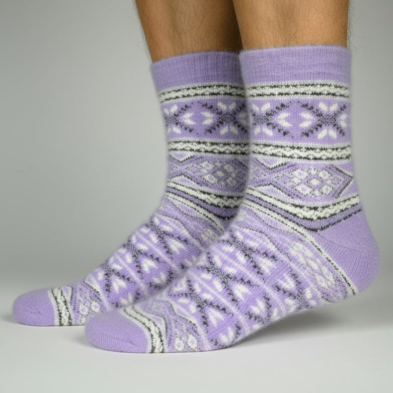 Purple patterned socks worn by a person on a gray background