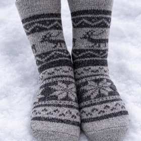 Gray patterned socks on a person standing in snow