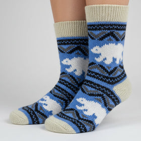Knitted sock with polar bear design on a white background