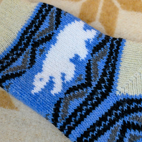 Close-up of a blue and black patterned fabric on a beige surface