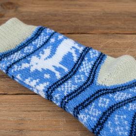 Knitted fabric with blue, white, and black pattern on a wooden table