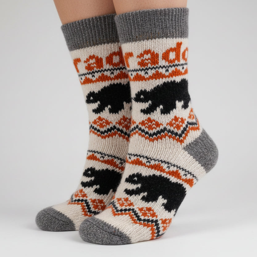 Knitted sock with bear design and 'Rado' branding on a white background