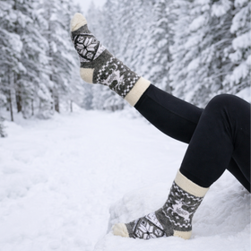 Person wearing patterned socks in a snowy forest