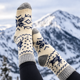 Person wearing patterned socks with a snowy mountain background