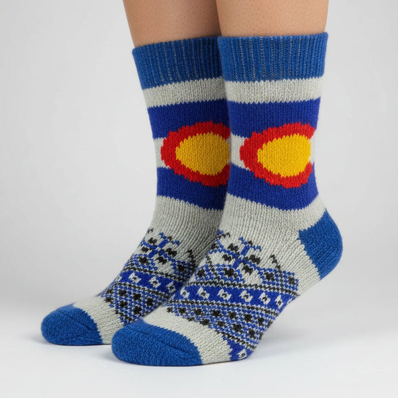 Colorful knitted sock with a sun design on a white background