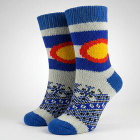 Colorful knitted sock with a sun design on a white background