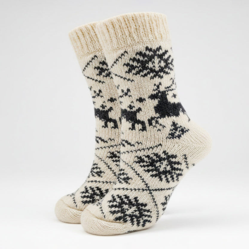 Pair of cream-colored socks with black pattern on a white background