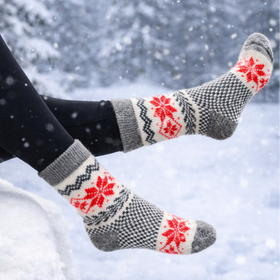 Person wearing patterned socks in a snowy setting