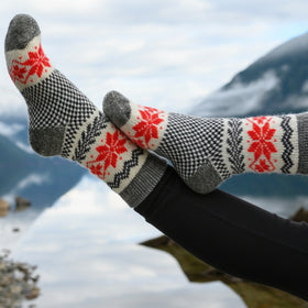 Person wearing patterned socks with a snowy mountain background