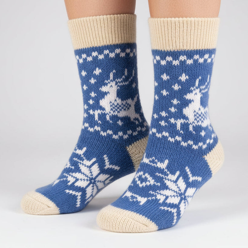 Blue sock with deer and snowflake pattern on a white background