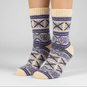 Knitted sock with purple and beige pattern on a white background