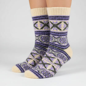Knitted sock with purple and beige pattern on a white background