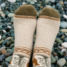 Pair of patterned socks on a pebble background