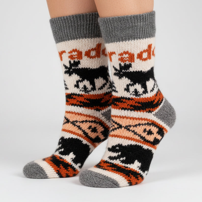 Knitted sock with animal pattern and 'raida' branding on a white background
