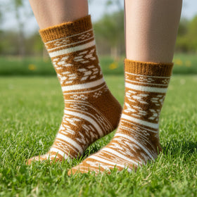 Brown and white patterned sock on a grass