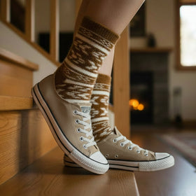 Brown and white patterned sock on a white background