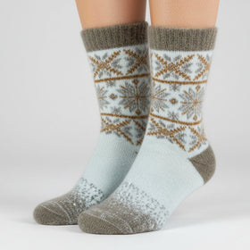 Knitted sock with a snowflake pattern on a white background