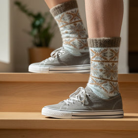 Knitted sock with a snowflake pattern on a white background