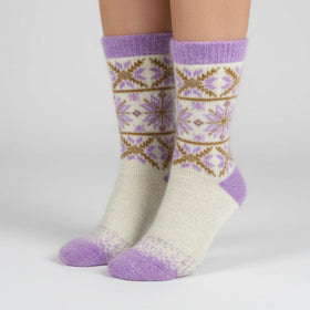 Knitted sock with a snowflake pattern on a white background