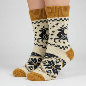 Knitted sock with reindeer design on a white background