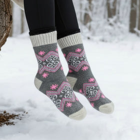 Person wearing patterned socks in a snowy forest setting