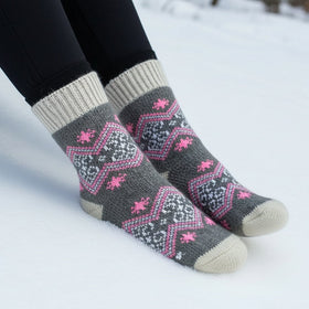 Gray socks with pink patterns worn in the snow